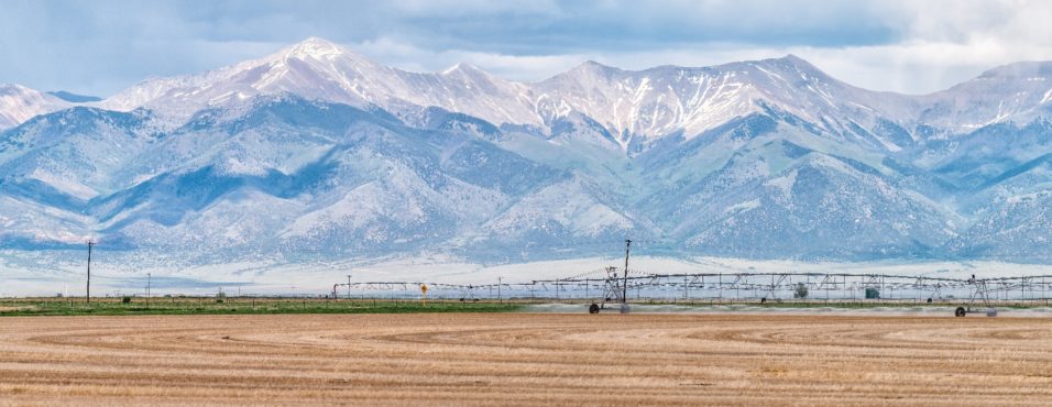 Monte Vista, Colorado farm field with irrigation and views of the Rocky Mountains; snowpacks